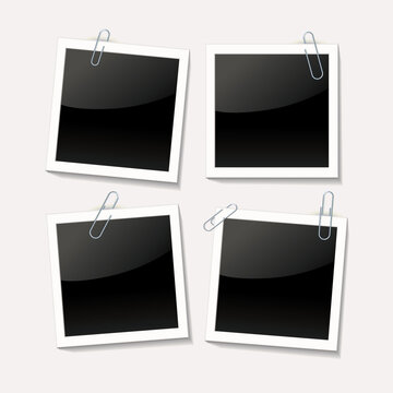 Photos are attached with a paper clip on a white background. Empty photo frame