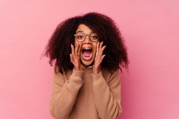Young african american woman isolated on pink background shouting excited to front.