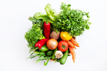 Fresh Vegetables in basket on white isolated background top view.	