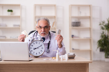 Experienced male doctor in time management concept
