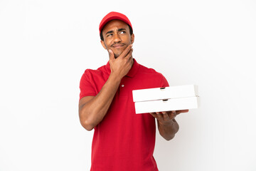 African American pizza delivery man picking up pizza boxes over isolated white wall having doubts