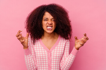 Young african american woman isolated on pink background upset screaming with tense hands.