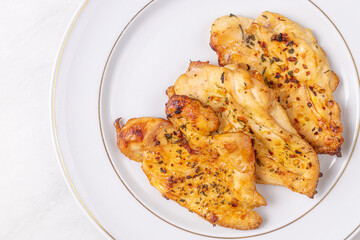 Delicious chicken breasts fried and served on the plate