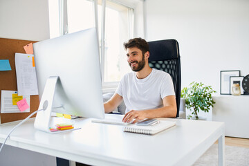 Young man programming from home while working remotely