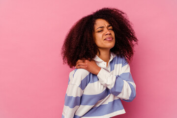 Young african american woman isolated on pink background having a shoulder pain.