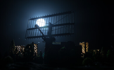 Silhouettes of satellite dishes or radio antennas against night sky. Space observatory or Air defence radar over dramatic night sky. Creative artwork decoration. Selective focus