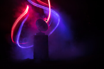 Silhouettes of satellite dishes or radio antennas against night sky. Space observatory or Air...