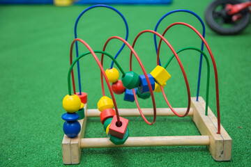 Toy Logic Maze with different figures on a green background