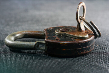 Old padlock with rust but fully functional photographed in the studio