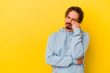 Obraz premium Young caucasian man isolated on yellow background who feels sad and pensive, looking at copy space.