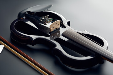 Modern electric violin and bow, closeup view