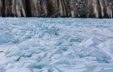 Scenic winter lake Baikal landscape with huge pressure ridge transparent ice blocks on the surface