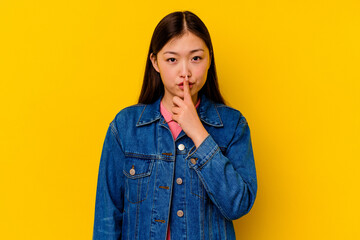 Young chinese woman isolated on yellow background thinking and looking up, being reflective, contemplating, having a fantasy.