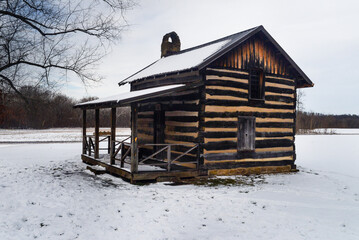 Log cabin in the woods during winter