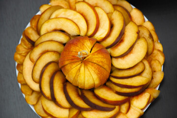 Fruit plate with juicy sliced peach. The peach is sliced.