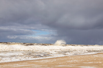 Winter coastal seascape with floating ice fragments on still cold water. Baltic Sea