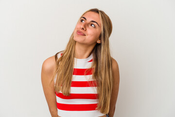 Young blonde caucasian woman on white background isolated dreaming of achieving goals and purposes