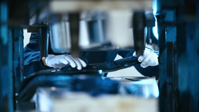 Worker fill the press machine with raw rubber material 4K