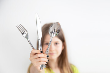 Girl with cutlery isolated on the white background
