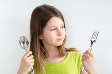 Girl with spoon and fork isolated on the white background