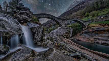 Ponte dei Salti double-arched medieval stone bridge in Lavertezzo, Switzerland during sunset