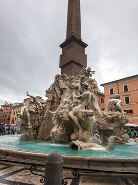 Rome, Italy - August 18, 2019: Bernini's Fountain of the Four Rivers with Obelisco Agonale, ancient obelisk in the center, close-up on cloudy day