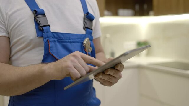 Plumber Working On Tablet, Ordering Plumbing Supplies Online, Maintenance