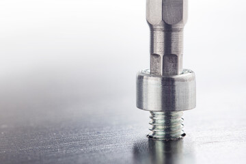 Hex drill bit screw hex bolt in metal steel plate. Spanner, bolt, screw and nuts.