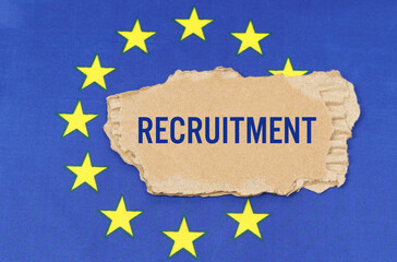 There is a cardboard box on the EU flag that says- RECRUITMENT