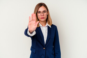 Young business caucasian woman isolated on white background standing with outstretched hand showing stop sign, preventing you.