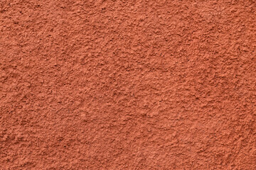 Fototapeta premium Decorative plaster of terracotta color with small pimples, wall surface.Overlay texture for interior or exterior design.Decorative render.Single-ply monolithic plaster decorative background and sample