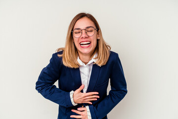 Young business caucasian woman isolated on white background laughs happily and has fun keeping...