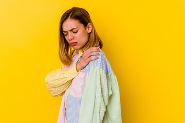 Young caucasian skinny woman isolated on yellow background having a shoulder pain.