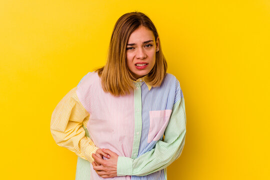 Young Caucasian Skinny Woman Isolated On Yellow Background Having A Liver Pain, Stomach Ache.