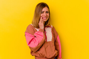 Young caucasian skinny woman isolated on yellow background having a strong teeth pain, molar ache.