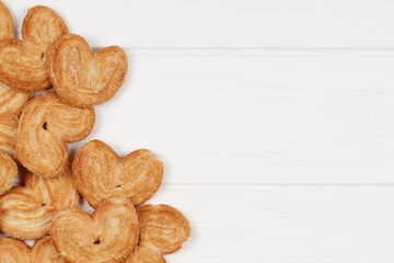 Cookies scattered on a white wooden table. Food.