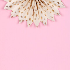 Curved paper circle on a pink background. 