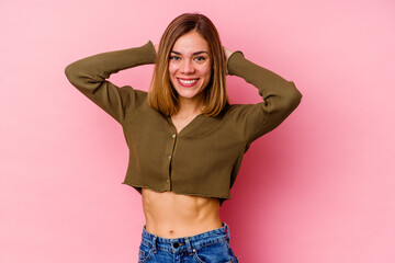 Young caucasian woman isolated on pink background feeling confident, with hands behind the head.