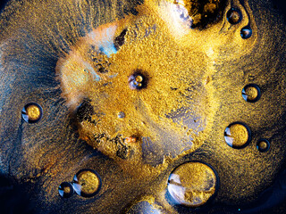 Macro Close Up Shot Of Golden Wet Glitter. Colorful Space Glittering Particle Background. Golden...
