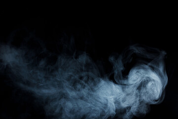 Abstract white smoke moves on black background. Beautiful swirling gray smoke.