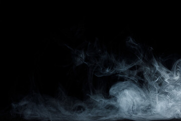 Abstract white smoke moves on black background. Beautiful swirling gray smoke.