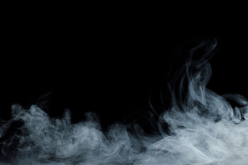 Abstract white smoke moves on black background. Beautiful swirling gray smoke.