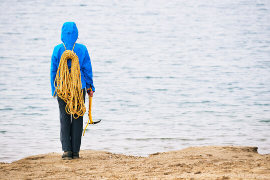 Alpinist on the shore of a lake