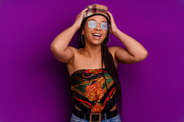 Young african american woman isolated on yellow background Young african american woman isolated on yellow background laughs joyfully keeping hands on head. Happiness concept.