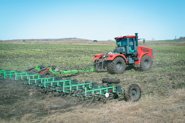 A tractor is working in a spring field.