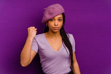 Naklejka premium Young african american woman isolated on yellow background Young african american woman isolated on yellow background showing fist to camera, aggressive facial expression.