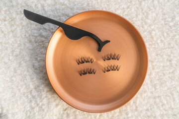 Magnetic eyelashes with applicator. Fake eye lashes with mini magnets for easy application. Beauty salon makeup trend.