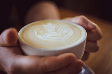 person holding a cup of coffee Scotland hospitality