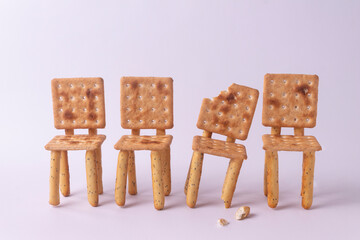 Figures of chairs made of cookies on a white background.