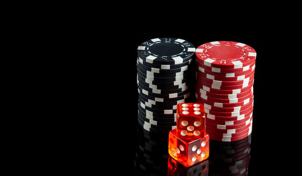 Dice with a maximum winning combination of twelve in craps on a black table and chips in the background